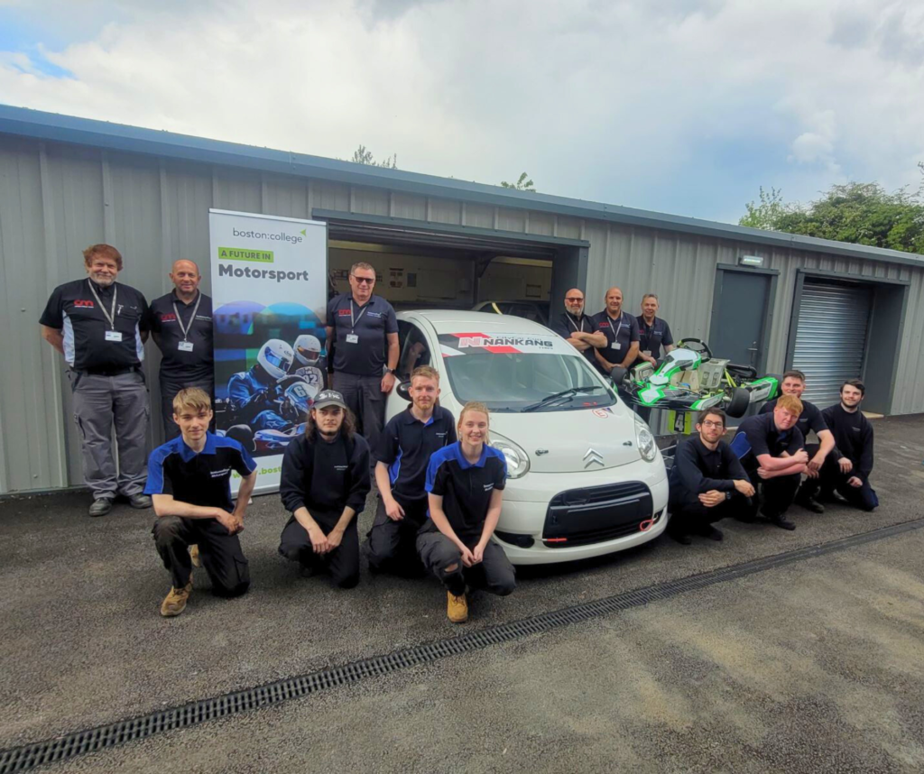 Boston College CityCar Cup Championship and Student Motorsport Challenge entry and their students outside their workshop in Licolnshire